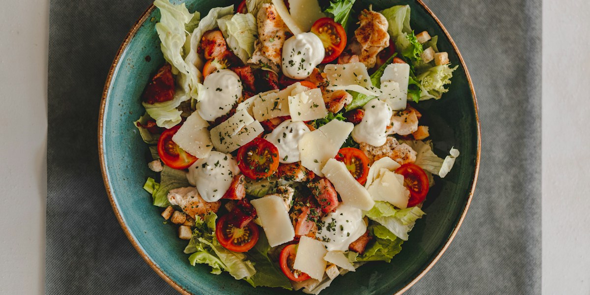 Fresh chicken salad with tomatoes and Parmesan